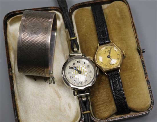 A 9ct gold wrist watch, a silver wrist watch and a silver serviette ring.
